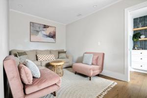 a living room with a couch and two chairs at Downtown CHS King Beds Convert to Singles in Charleston