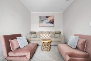 a living room with two couches and a table at Downtown CHS King Beds Convert to Singles in Charleston +35 photos
