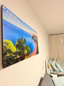 a picture of a beach on the wall of a room at Castle Harbour 209 in Los Cristianos