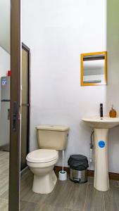 a bathroom with a toilet and a sink at Cabaña El Sargento in San Francisco