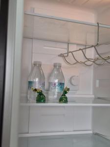 two water bottles sitting on a shelf in a refrigerator at Apartamento click center in Ronda
