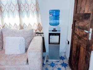 a living room with a couch and an oven at Diamond luxury Studio Watamu in Watamu