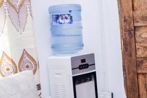 a computer with a bottle of water on top of it at Diamond luxury Studio Watamu in Watamu