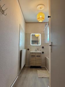 a bathroom with a sink and a refrigerator at L'Echappée Belle in Paray-le-Monial