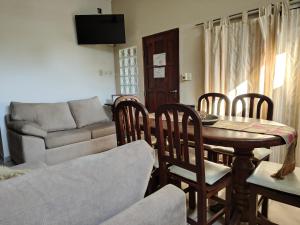 a living room with a table and chairs and a couch at Alojamientos Estrellas Azules in Colón