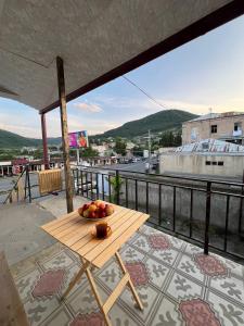 a table with a bowl of fruit on a balcony at Noyemberyan Central Apartment in Noyemberyan