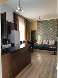 a kitchen and a living room with a couch at Noyemberyan Central Apartment in Noyemberyan +9 photos