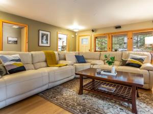 a living room with a white couch and a coffee table at Naturbyn Retreat in Glacier