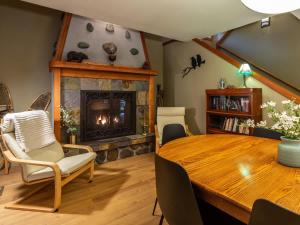a living room with a table and a fireplace at Naturbyn Retreat in Glacier