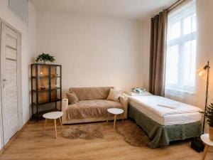a living room with a bed and a couch at Gdańsk in Gdańsk
