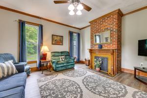 a living room with a couch and a fireplace at Mtn Views & Idyllic Setting! Clifton Forge Retreat in Clifton Forge