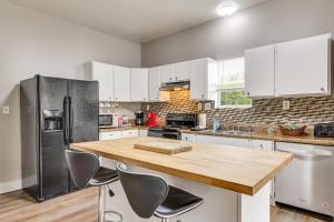 a kitchen with white cabinets and a wooden counter top at Mtn Views & Idyllic Setting! Clifton Forge Retreat in Clifton Forge
