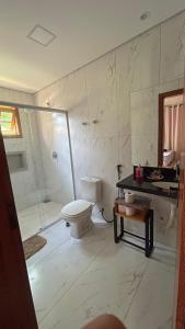 a bathroom with a toilet and a shower at A Casa da lua in Lagoa Santa