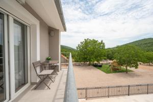 a balcony with a view of a yard at Villa Sky Stone, Heated Pool, Playground in Krstatice