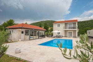 a villa with a swimming pool and a house at Villa Sky Stone, Heated Pool, Playground in Krstatice