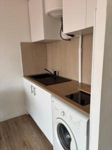 a small kitchen with a washing machine and a sink at Studio 7 in Fos-sur-Mer