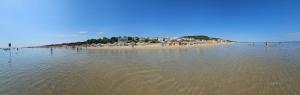 a beach with a group of people on the shore at Casa Delia in Piazzano +5 photos