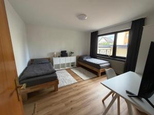 a living room with two beds and a window at Landhaus zur Sonne in Bad Camberg