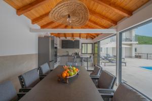 a bowl of fruit sitting on a table in a kitchen at Villa Sky Stone, Heated Pool, Playground in Krstatice