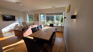 a living room with a wooden table and a couch at Húsavík Apartment in Húsavík