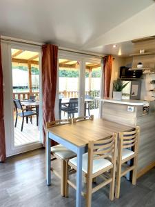 a kitchen and dining room with a table and chairs at Le Soléa in Le Cailar