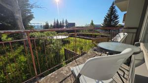 a patio with a table and chairs on a balcony at Húsavík Apartment in Húsavík