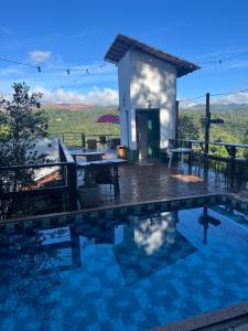 a villa with a pool and a house at Villa Macacos in Nova Lima