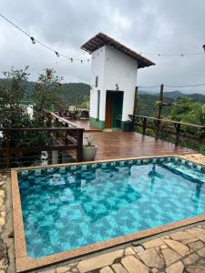 a swimming pool in front of a house at Villa Macacos in Nova Lima +24 photos