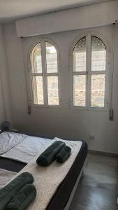 a bedroom with two beds and two windows at Casa de la Luz del Sol in Mojácar +21 photos