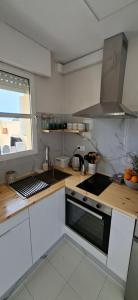 a kitchen with a sink and a stove top oven at Casa de la Luz del Sol in Mojácar