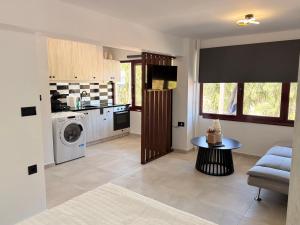 a kitchen with a washing machine and a table at Electra Chios apartment in Chios