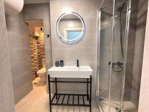 a bathroom with a sink and a mirror at Electra Chios apartment in Chios