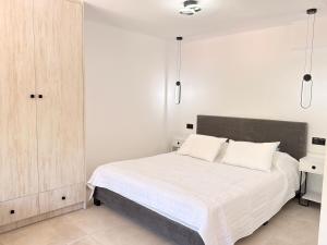 a bedroom with a white bed with two white pillows at Electra Chios apartment in Chios