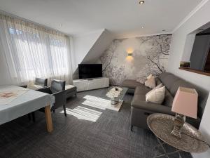 a living room with a couch and a tv at Ferienhaus Nehring in Bad Neuenahr-Ahrweiler