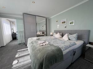 a bedroom with a large bed with a large mirror at Ferienhaus Nehring in Bad Neuenahr-Ahrweiler