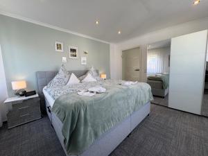 a bedroom with a large bed with two towels on it at Ferienhaus Nehring in Bad Neuenahr-Ahrweiler
