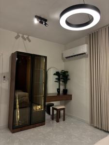 a living room with a glass cabinet and a table at Bloom Home in Al Khobar