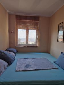 a bedroom with two beds and a window at Apartmani Bozenov in Petrovac na Moru +7 photos