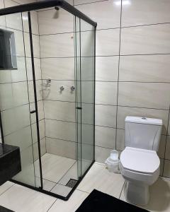 a bathroom with a shower and a toilet at Hotel Villa Real in Pôrto Britânia