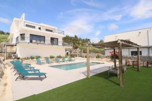 a villa with a swimming pool and a house at Peace House Lourinhã - Villa 8 in Lourinhã