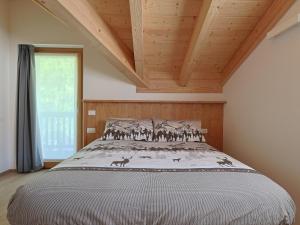 a bedroom with a large bed with a wooden ceiling at Bormio BM0 - Tutta Bormio a Zero stress in Bormio