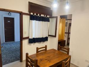 a dining room with a wooden table and chairs at Espacio493 in Villa Gesell +50 photos