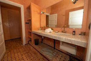 a bathroom with two sinks and a large mirror at Villa Dar Luz in Marrakesh +68 photos