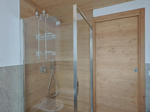 a shower in a bathroom with a wooden wall at Bormio BM0 - Tutta Bormio a Zero stress in Bormio +37 photos