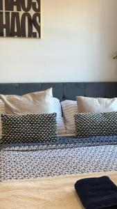 a bed with several pillows on top of it at Sutton & Stone in Sutton +5 photos