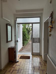 an open door to a hallway with a tile floor at Sonnenblick Kleiberweg in Mosbach