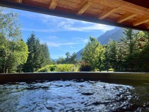a hot tub with a view of the mountains at Chalet Isabelle Mountain lodge 5 stars 6 bedroom en suite sauna spa inox in Chamonix +74 photos