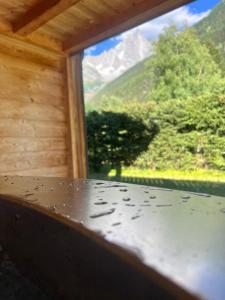 a window with a view of a mountain at Chalet Isabelle Mountain lodge 5 stars 6 bedroom en suite sauna spa inox in Chamonix