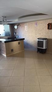 an empty room with a kitchen and a heater at Hotel em Caçu in Caçu
