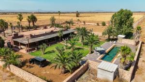 an aerial view of a house with a pool and palm trees at Villa Dar Luz in Marrakesh